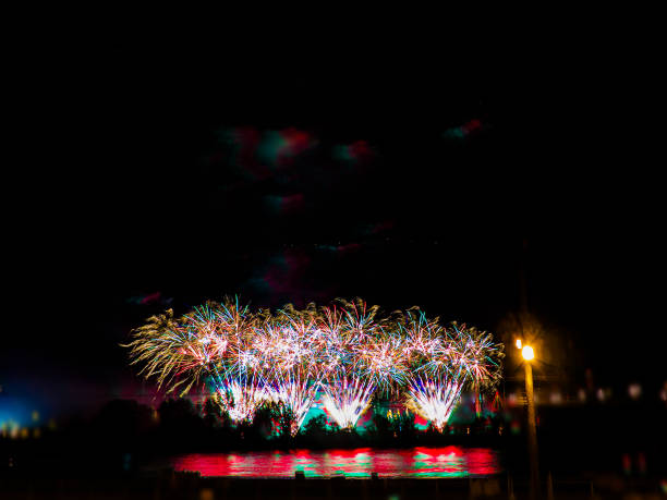 istock Colorful fireworks with multiple bursts against dark sky with copy space at the top 831837074