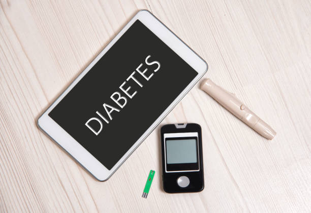 digital tablet with the word diabetes with  glaucometer and needle - diabetes glaucometer healthcare and medicine close up imagens e fotografias de stock