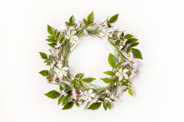 istock Frame wreath with flowers, branches, leaves and petals isolated on white background. Flat lay, overhead view. 831844070