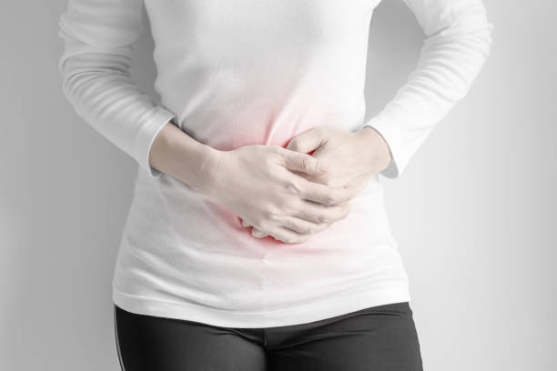 istock Woman stomachache on gray wall background. 831844928