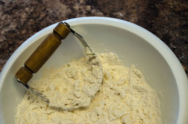 Pie crust preparation using pastry blender stock photo