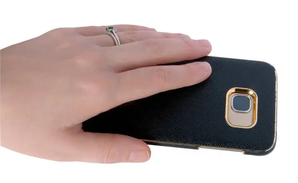 Female hand holding a smart phone with a case  on it.
