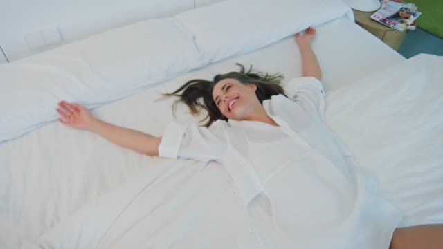 Woman falling in bed