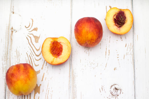 istock a lot of fresh peaches on a white table. Top view. 831860878