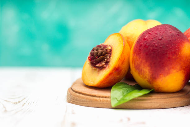 istock a lot of fresh peaches on a white table 831860916