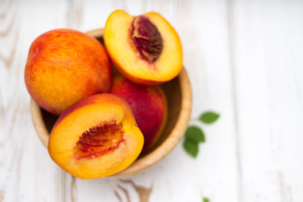 istock a lot of fresh peaches on a white table 831860922