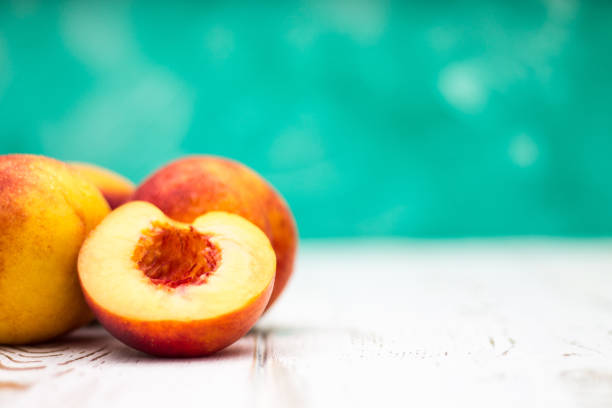 istock a lot of fresh peaches on a white table 831861076