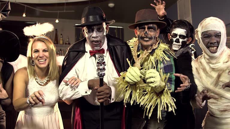 Six multi-ethnic adults at costume party