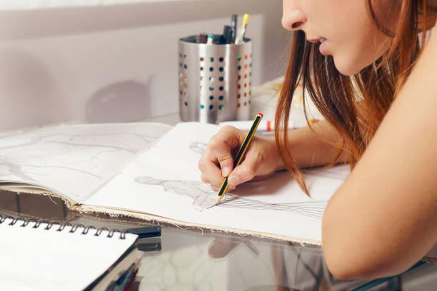 istock Fashion designer working on drawing sketches. 831865048