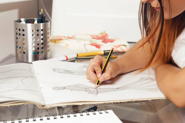 istock Fashion designer working on drawing sketches. 831865096