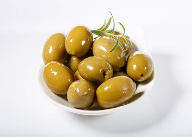 istock Whole green olives in white bowl 831871682