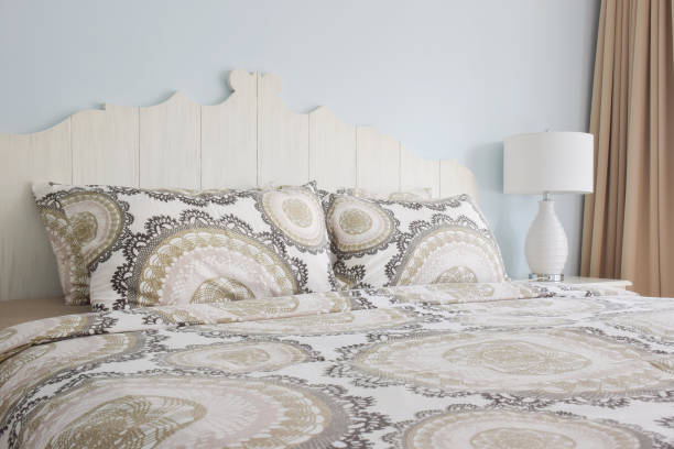 istock Retro style bedding with white reading lamp and light blue wall 831872070