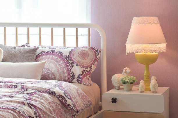 istock Cozy bedroom interior with pillows and reading lamp on bedside table 831872158