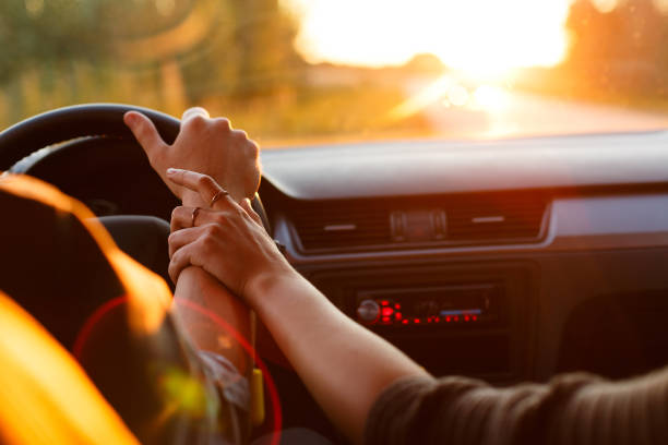 istock Couple driving car on way to sunset 831873314