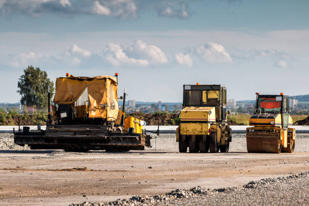 istock Asphalt paver and two tandem rollers for road repair 831875750