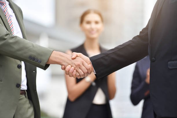 istock Happy business people handshaking. 831879914