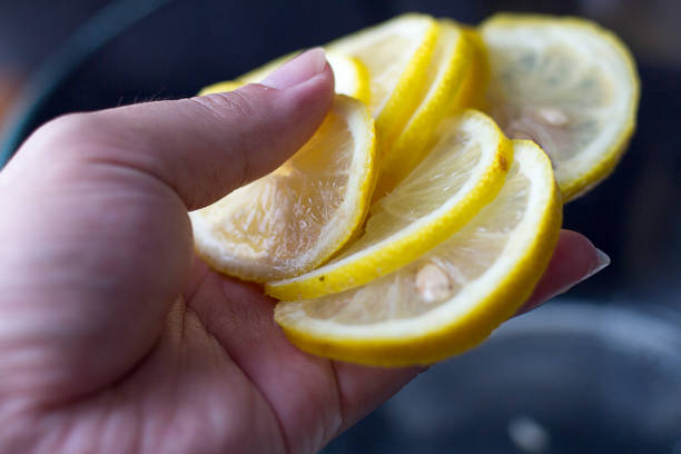 istock Hand holding slices of lemon slices 831884144