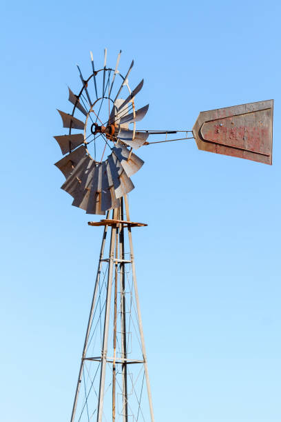 istock Water Pumping Windmill Against Clear Blue Sky 831884426