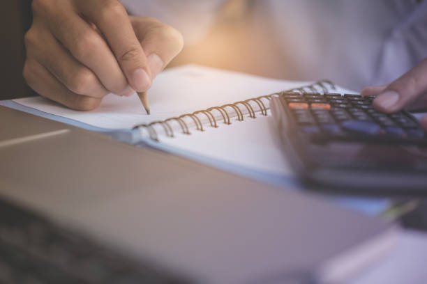 istock Financial data analyzing hand writing and counting on calculator in office shop cafe with vintage filter 831887606