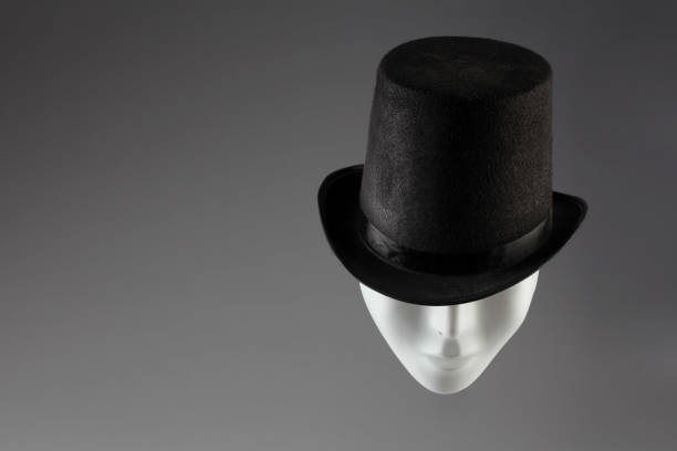istock White mask hiding eyes under black top hat on grey background with copy space. Incognito concept 831888210