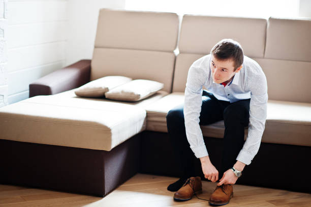 istock Portrait of a handsome groom dressing up and getting ready for his wedding. 831896882
