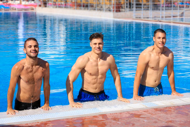 istock Three man getting out of swimming pool and smiling 831897408