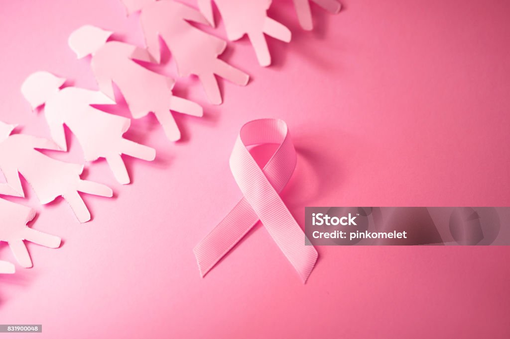 The Sweet pink ribbon shape with girl paper doll on pink background  for Breast Cancer Awareness symbol to promote  in october month campaign Sweet pink ribbon shape with girl paper doll on pink background  for Breast Cancer Awareness symbol to promote  in october month campaign Adult Stock Photo