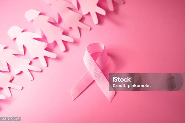 The Sweet Pink Ribbon Shape With Girl Paper Doll On Pink Background For Breast Cancer Awareness Symbol To Promote In October Month Campaign Stock Photo - Download Image Now