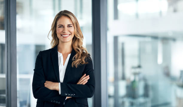 I've solidified my name in the business world Shot of a confident young businesswoman standing in a modern office business suit stock pictures, royalty-free photos & images