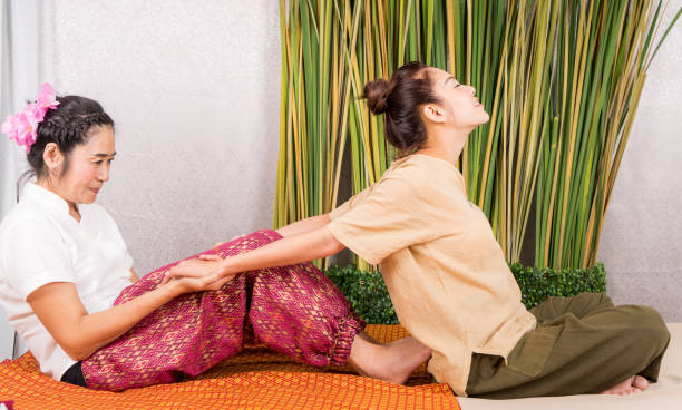 istock Women is getting her arm stretched by Thai Massage therapist 831902926