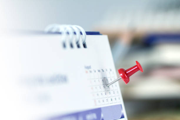 Red pushpin on calendar page for remind and marked important events