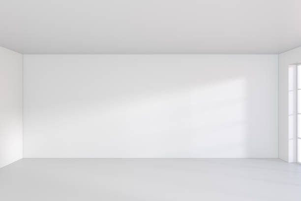 istock Large room with windows and falling light from the window on the wall. 3D rendering 831918784