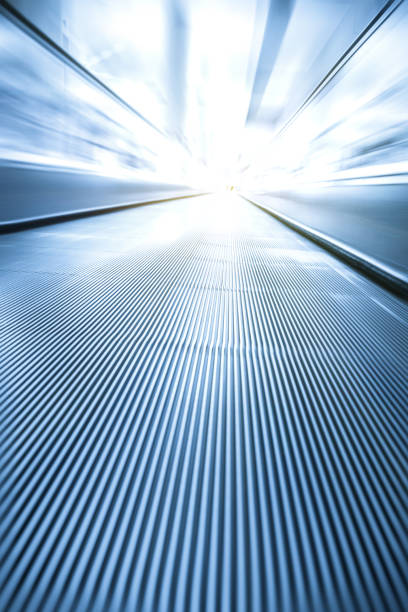 istock escalator in radial blur in airport 831919924