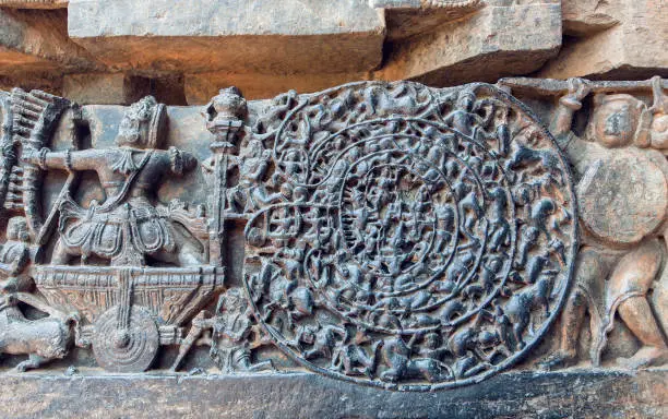 Hindu epic Mahabharata scene on carvings. Story of warrior Abhimanyu entering the Chakravyuha on stone artworks of the 12th century Hoysaleshwara temple in Halebidu, India.