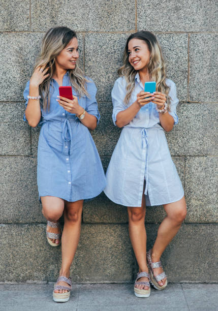 istock Twins texting in the city 831933688