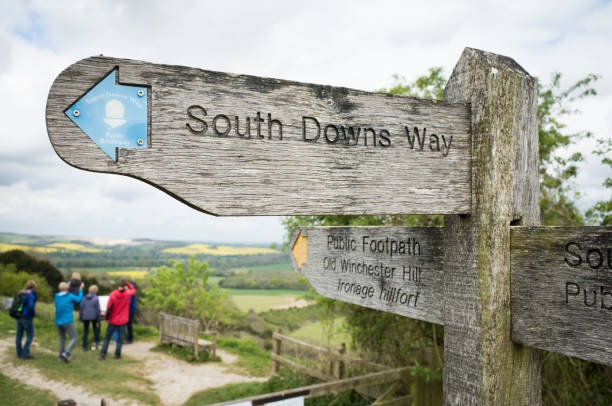 South Downs Way Public Footpath Petersfield, England - April 29, 2017: Group of walkers visit Old Winchester Hill, on the South Downs Way public footpath in Hampshire. petersfield stock pictures, royalty-free photos & images