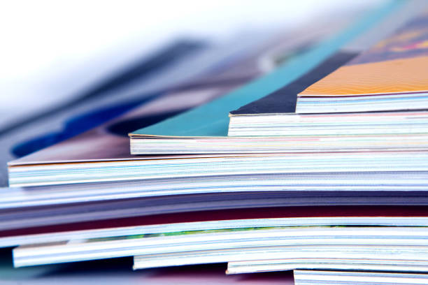 stack of colorful magazines , extreamly dof - news magazine imagens e fotografias de stock