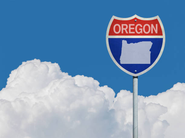 istock Highway sign for Interstate road in Oregon with map in front of clouds 831947550
