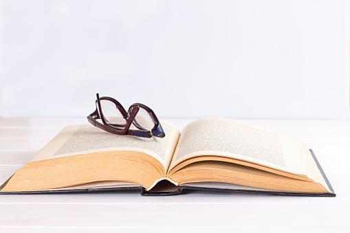 glasses and book on the white background