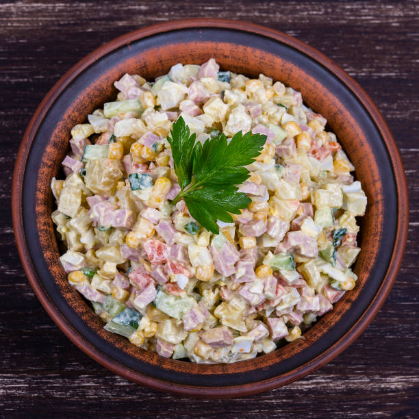 istock Russian traditional salad olivier with pea in the plate. 831961932