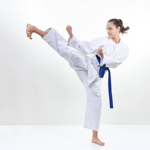 istock A girl with a blue belt beats kick leg 831968522