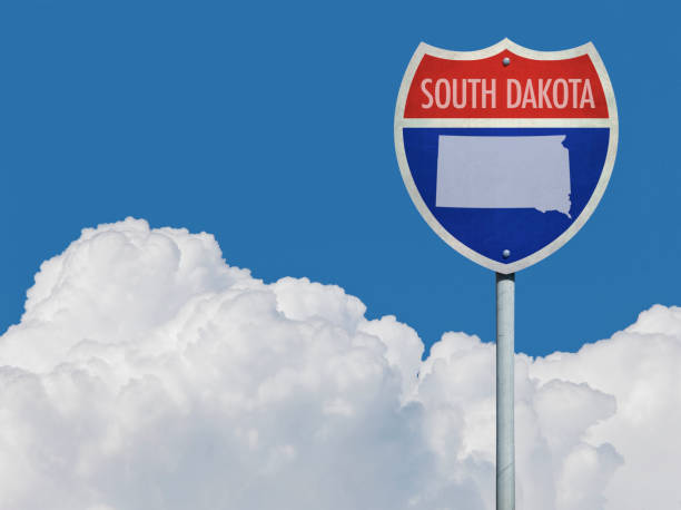 istock Highway sign for Interstate road in South Dakota with map in front of clouds 831971138