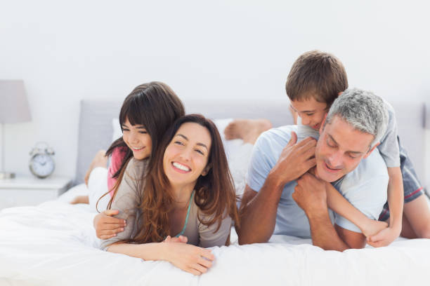 istock Cute family lying together 831978238