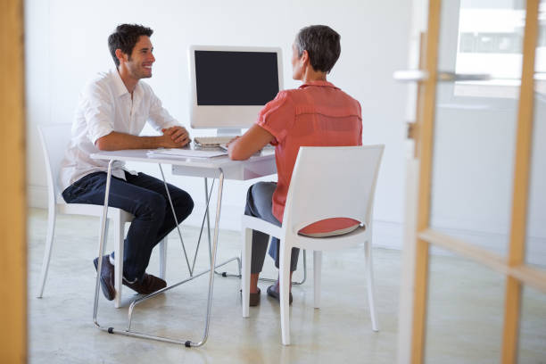 istock Casual business people talking at desk and smiling 831978382
