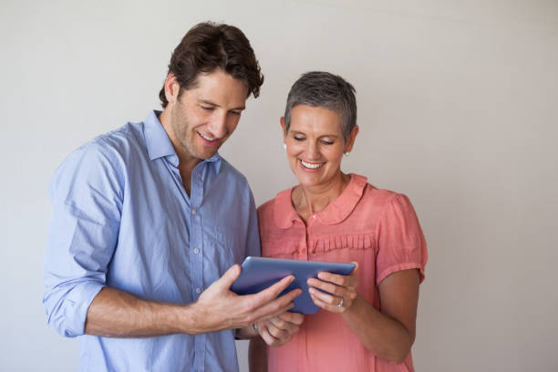 istock Casual smiling business team looking at tablet pc together 831979446