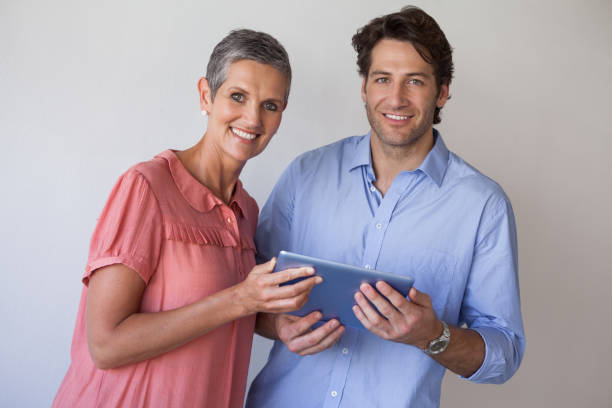 istock Casual smiling business team looking at tablet pc together 831979576