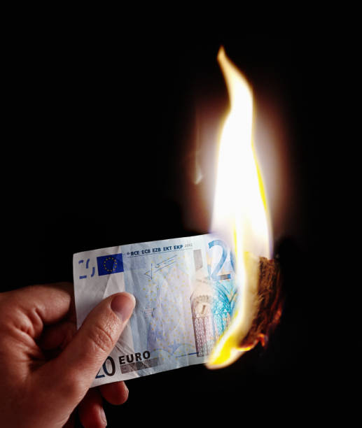 istock Hand holds burning 20 Euro banknote 831992154