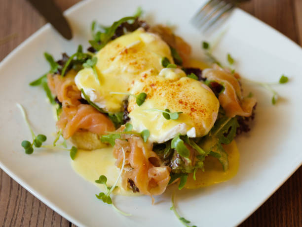 istock Poached eggs on a plate. Close-up of baked spicy eggs with salmo 831992346