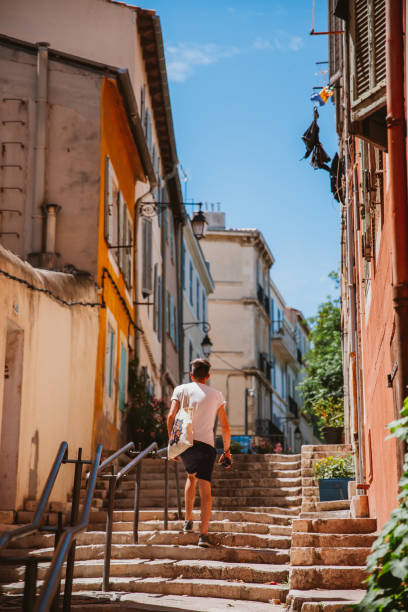 The quarter basket in Marseille Marseille, France - June 13th, 2016: Tourists strolling in the old town of Marseille, France. marseille panier stock pictures, royalty-free photos & images