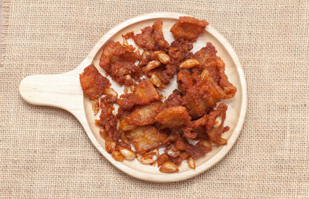 istock Fried Pork with Garlic Pepper on wooden plate 831999810